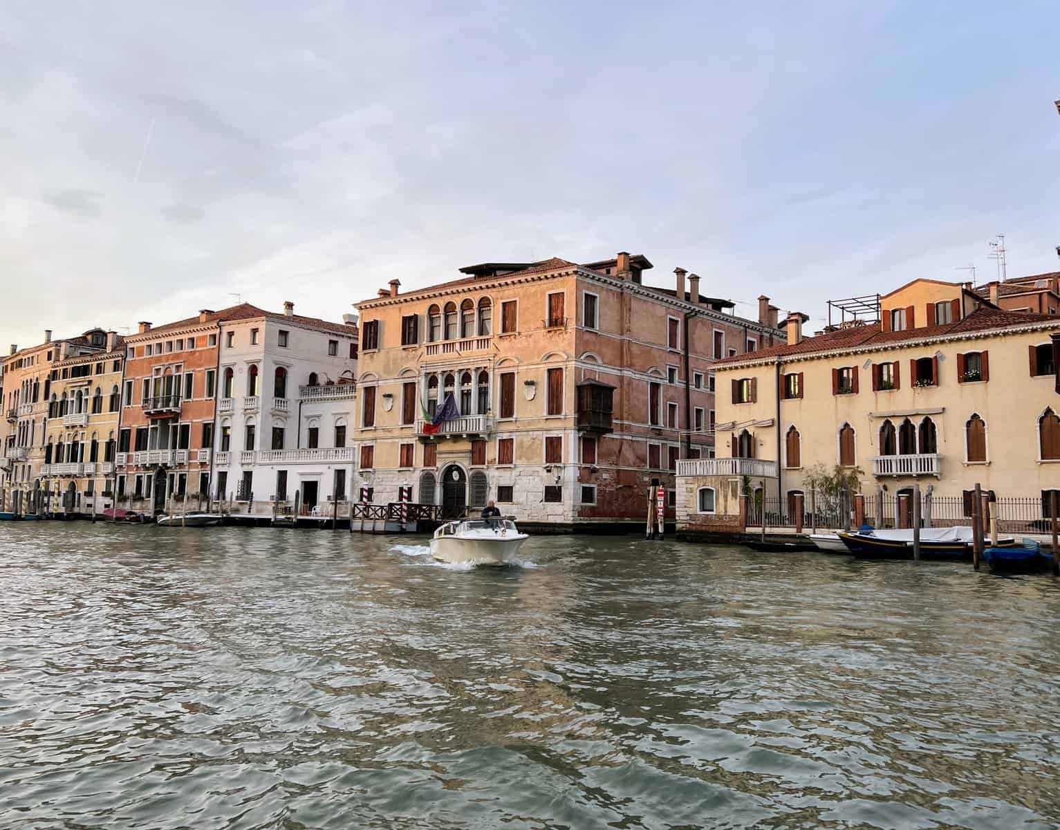 Venice Grand Canal From Vaporetto Boat Venetian Buildings And Speedboat At Sunset