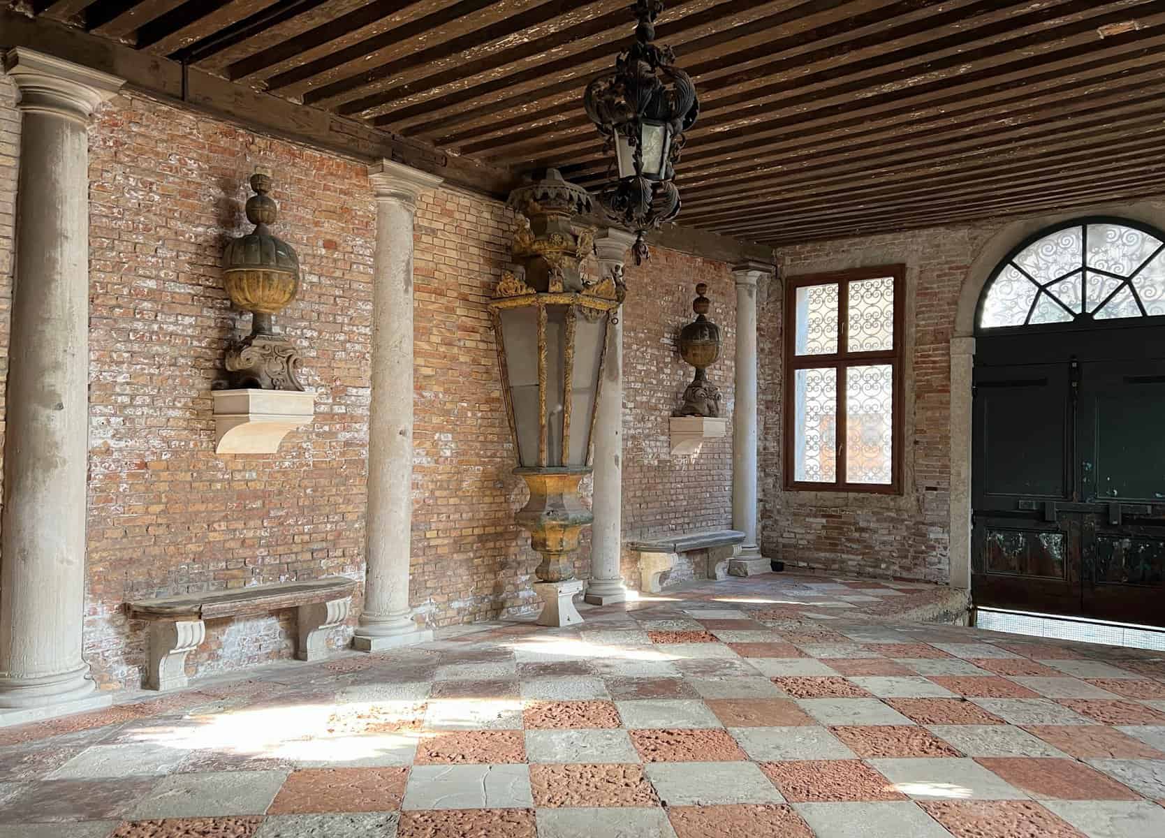 Palazzo Gradenigo Venice Interior Ground Floor Brick Wall With Stone Columns And Large Lamp