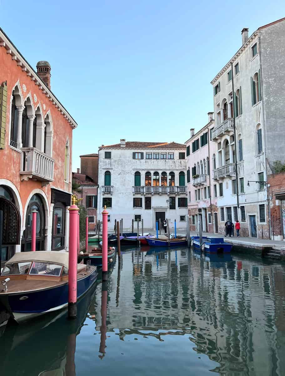 Venice Santa Croce Sestiere Neighborhood Canal With Boats And Pink Poles