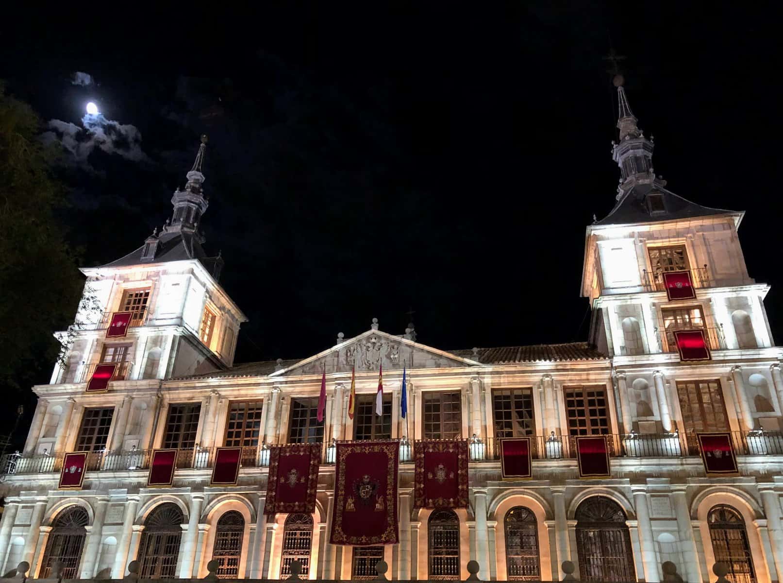 Toledo Spain Town Hall Ayuntamiento Two Towers At Night With Flags And Lights Full Moon