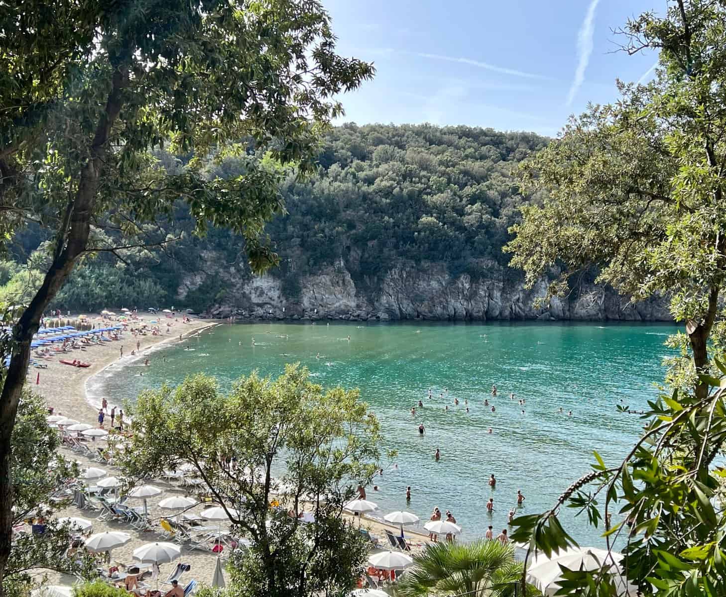 Ischia Island Italy San Montano Beach People Bathing In Jade Green Sea White Umbrellas On Sand