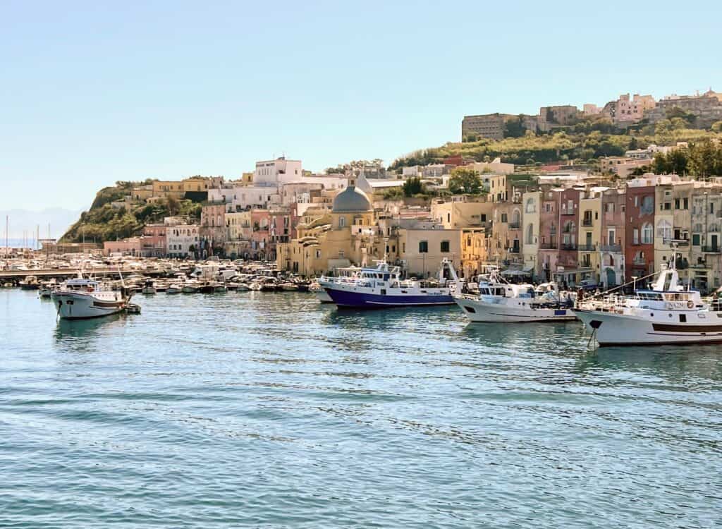 Procida Island Italy View Of Port From Ferry Morning Light Pastel Buildings Boats Bay Of Naples