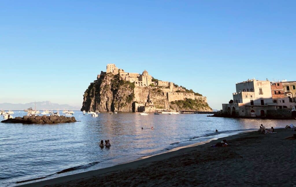 Ischia Ponte Pescatori Beach View Of Castello Aragonese People Swimming Evening Light