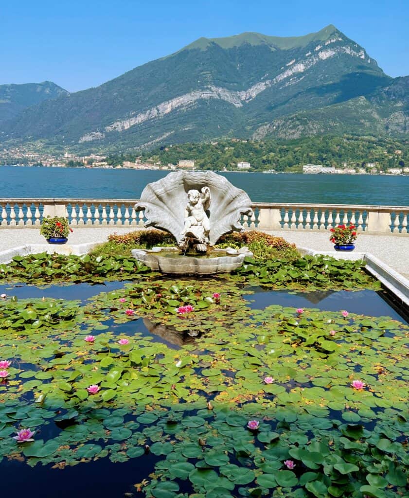 Lake Como Villa Melzi Bellagio Water Lillies In Pond With Classical Cherub Statue Lakeside Garden