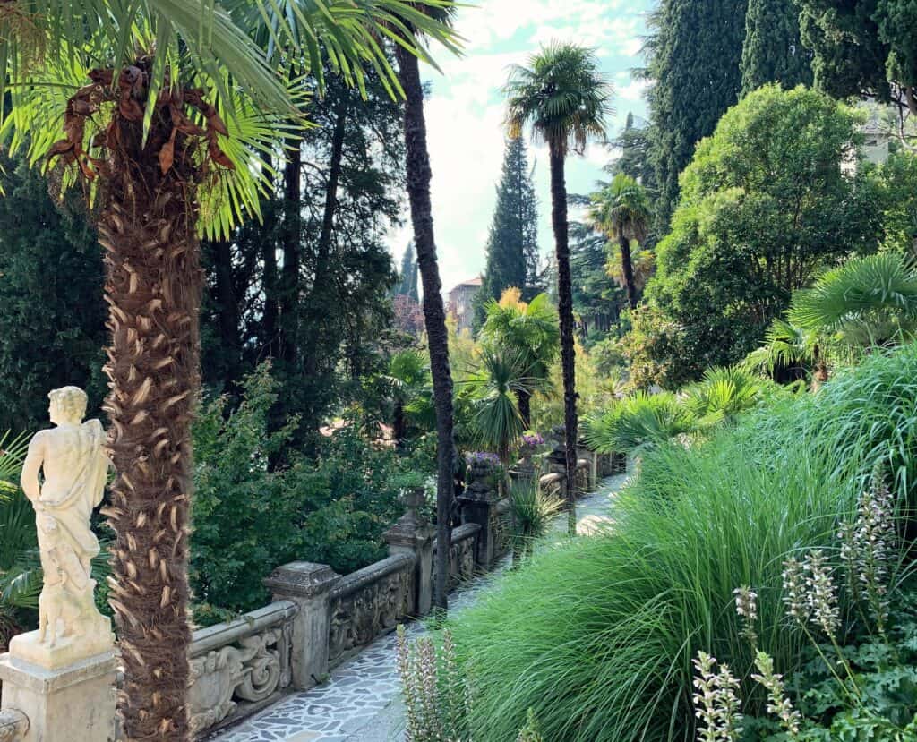 Lake Como Villa Monastero Garden Varenna Lush Foliage Palm Trees And Classical Statue