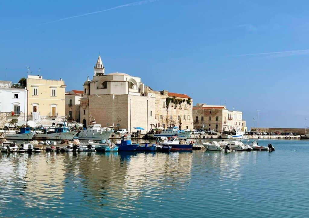 Trani Puglia Harbor Blue Boats White Stone Buildings Reflected In Water