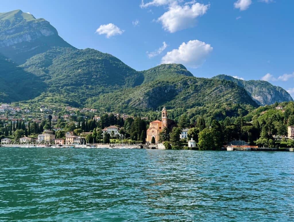 Lake Como View Of Tremezzo From Ferry Mountains With Church And Bell Tower