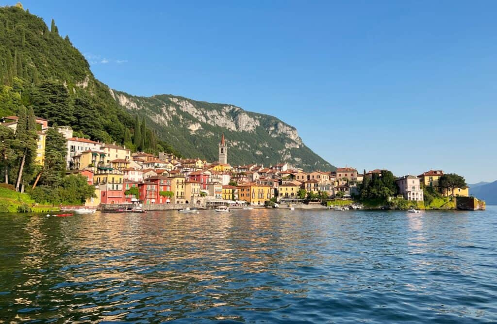 Varenna Lake Como View From Ferry Colorful Houses And Bell Tower With Mountains