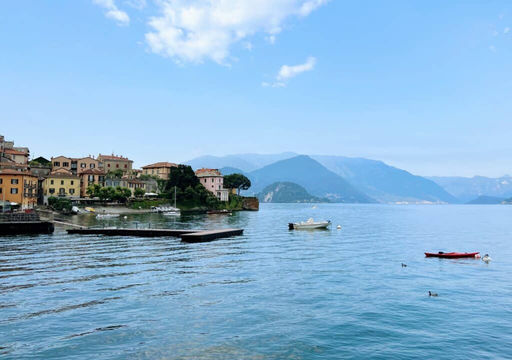 Varenna Lake Como Early Morning Moored Boats Mountains Pastel Houses