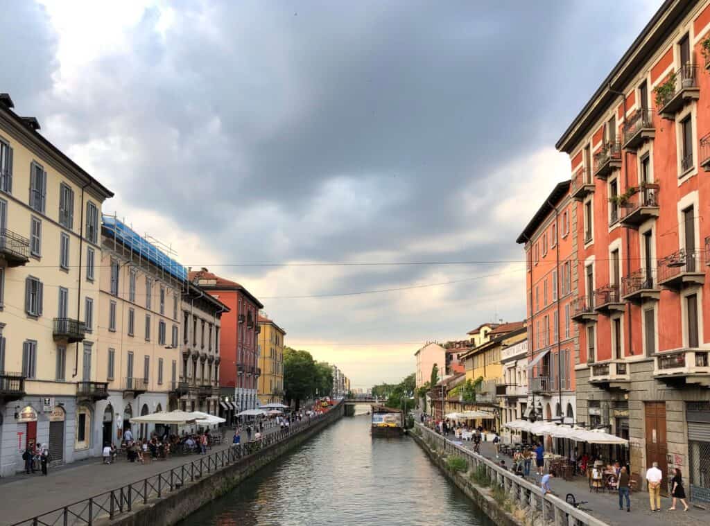 Milan I Navigli District Canal At Sunset Cafe Umbrellas Pedestrians