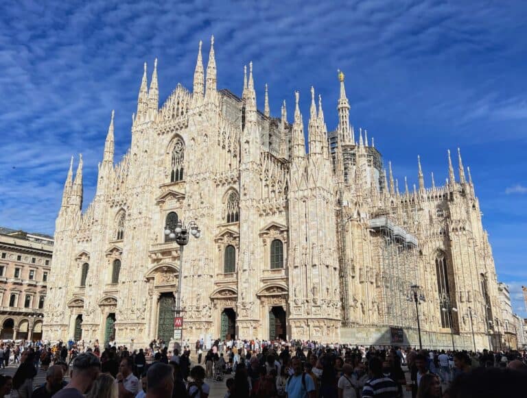 Milan Piazza Del Duomo Cathedral Marble Facade With Gothic Spires Crowds In Shadow