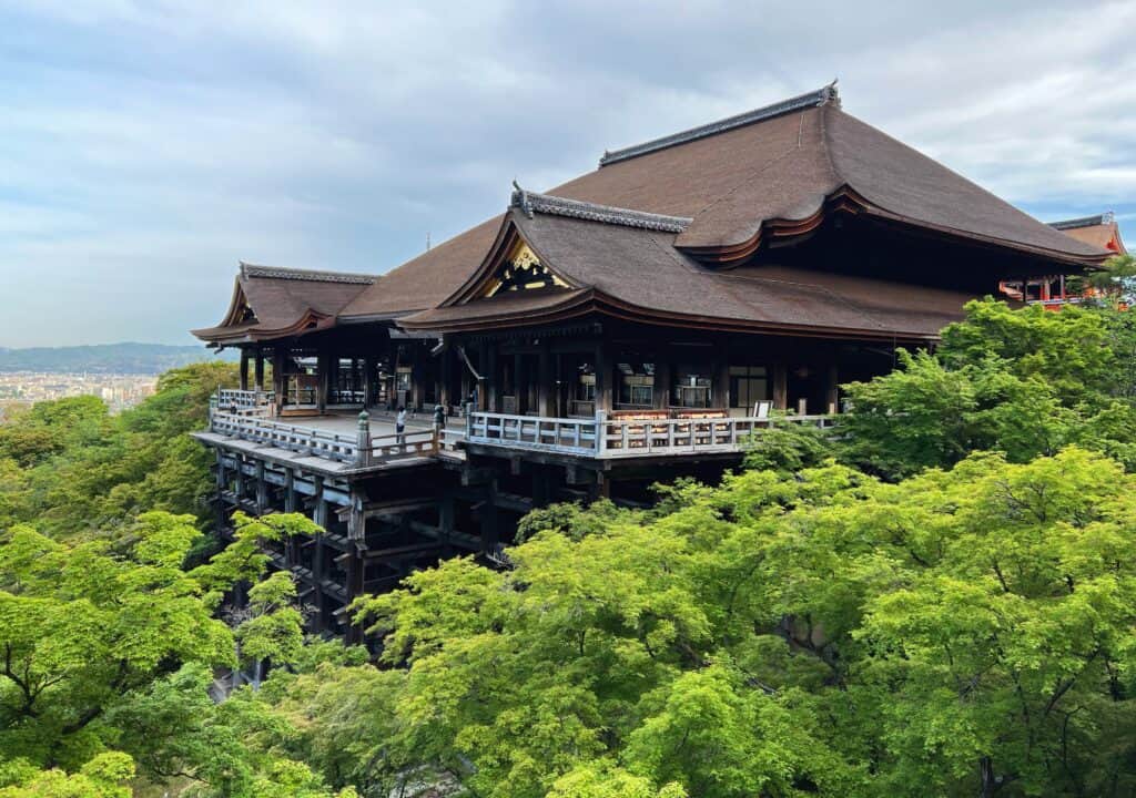 Kiyomizu-dera Temple View Of Roof And Green Maple Trees And Kyoto In Distance