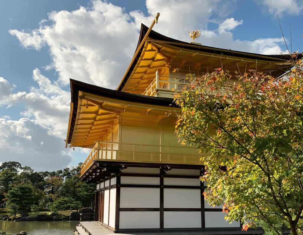 Kinkaku-ji Golden Pavilion Exterior On Pond With Gold Facade On Upper Level And White Plaster On Lower Level