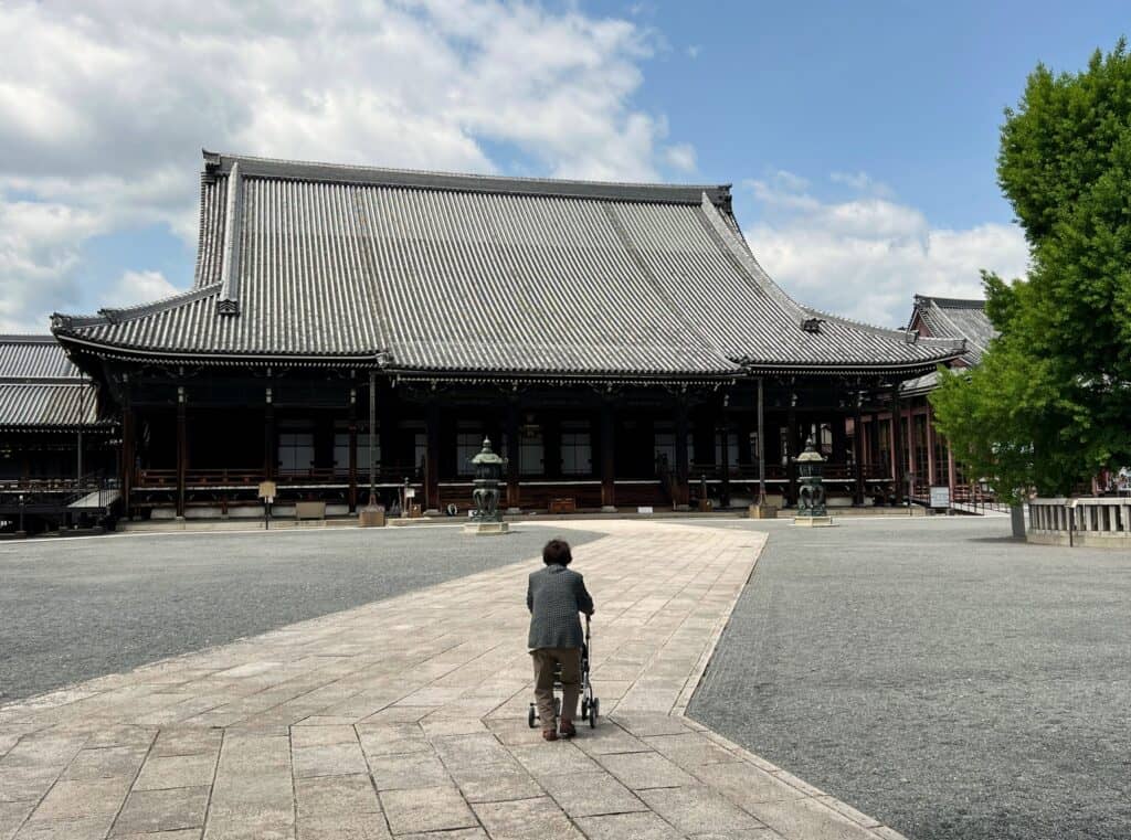 Kyoto Nishi-Hongwan-ji Wooden Temple Exterior Hip And Gable Roof 16th Century And Person With Stroller