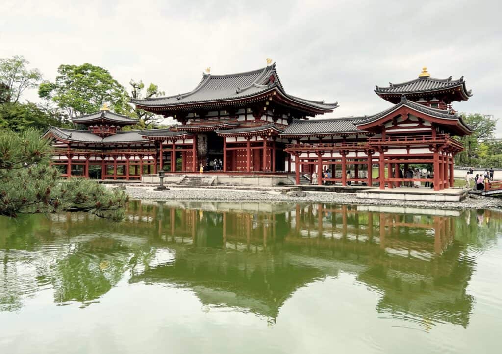 Byodo-in Uji Phoenix Hall Front View Sloped Roofs White With Red Painted Wood Reflected In Water Japanese Architecture